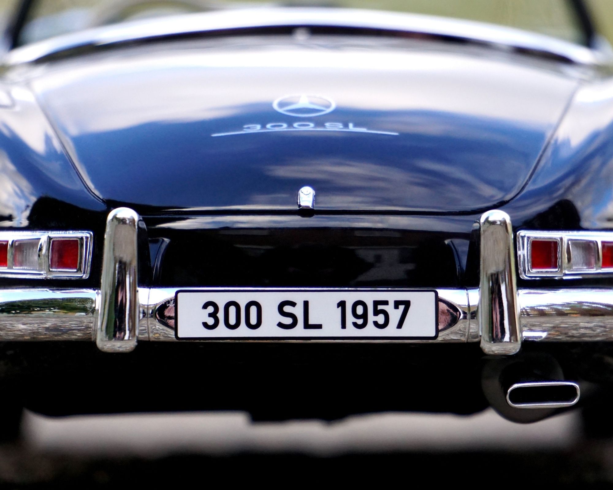 A blue car moving to Longboat Key with license plate 300 SL 1957 .