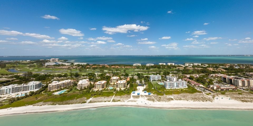 An aerial photo of Longboat Key Club condos that line the coastline in one of Longboat Key's historic neighborhoods.