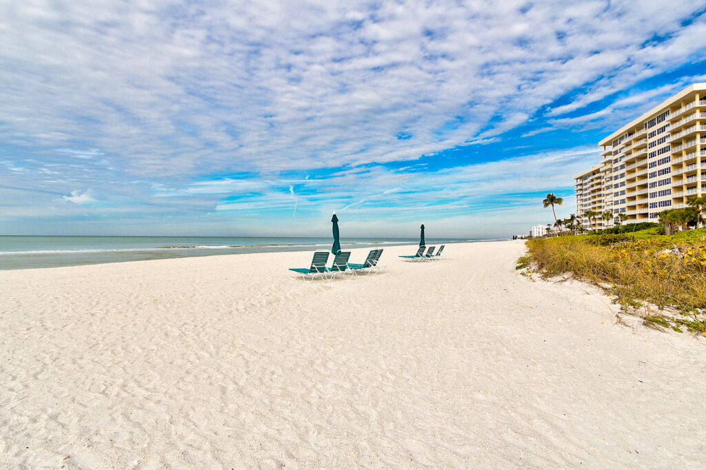 A view taken from the beach of condos lining the coast including the Sanctuary Longboat Key for sale.