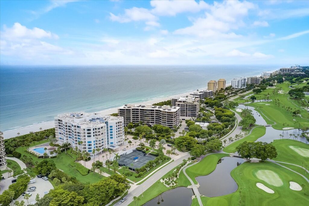 An aerial view of the Pierre Longboat Key condos with its white building sitting along 420 feet of beachfront.
